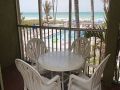 Lanai with table set & beach view
