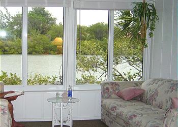 Canal front covered porch with lovely furniture